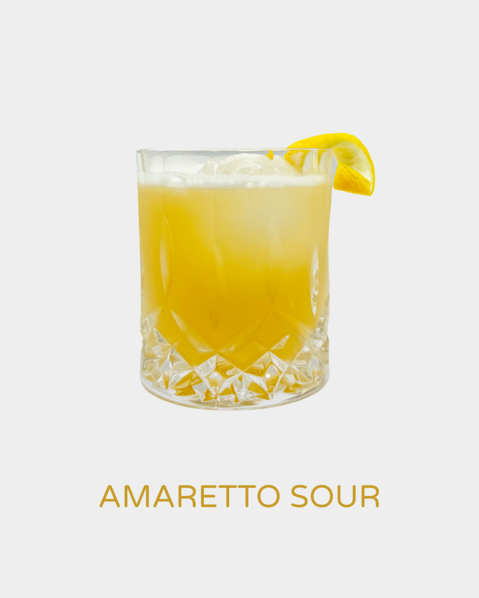 Amaretto Sour cocktail in a crystal glass with a rich golden hue, frothy top, and a lemon wedge garnish. A smooth, nutty, and citrusy cocktail crafted with handcrafted organic limoncello from Iannetelli Liqueurs.