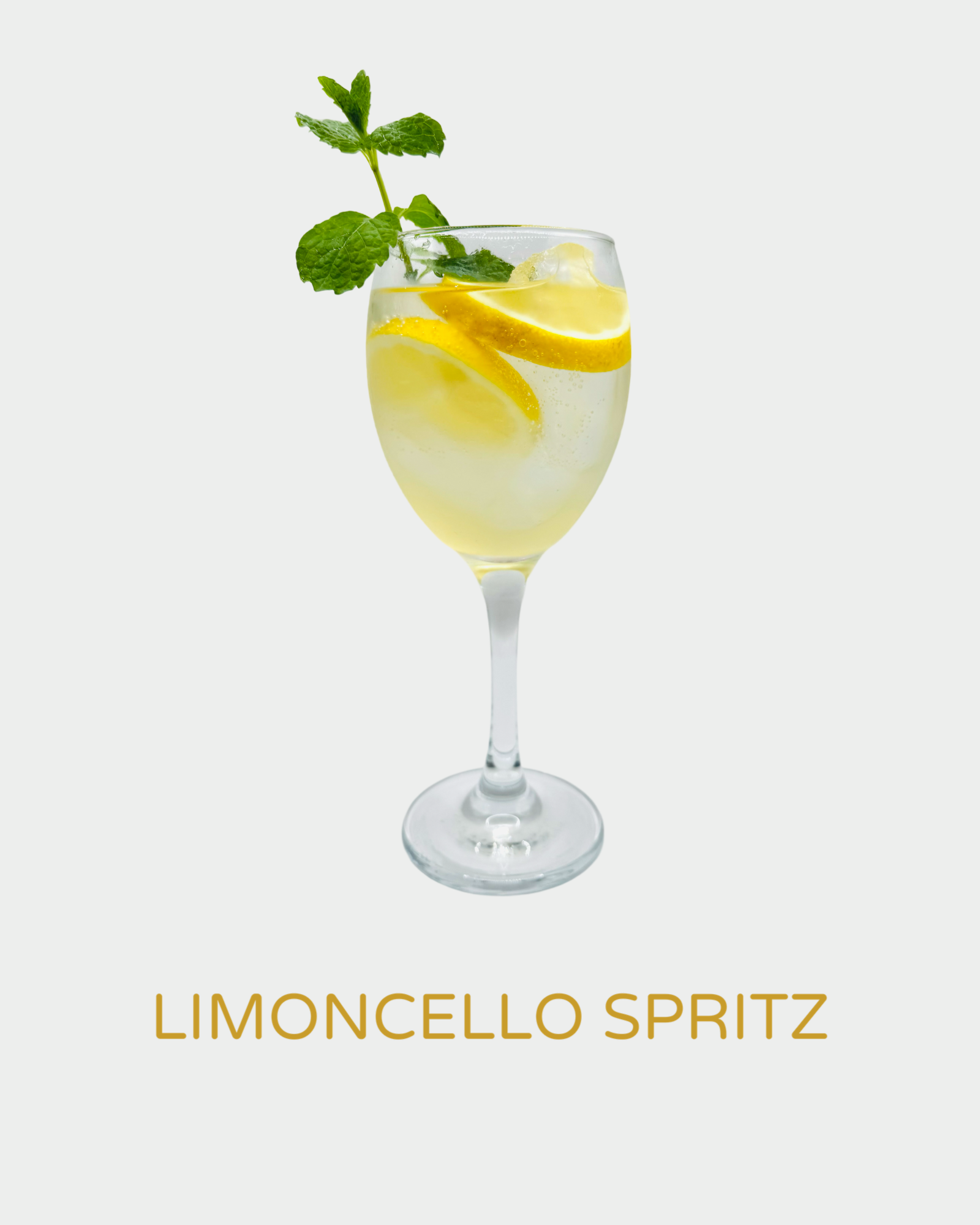 Limoncello Spritz cocktail in a wine glass with ice, fresh lemon slices, and a mint garnish. A refreshing Italian-inspired drink made with handcrafted organic limoncello from Iannetelli Liqueurs